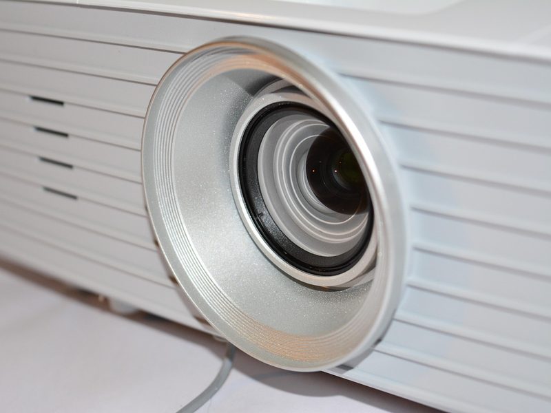 Close-up of a white video projector lens