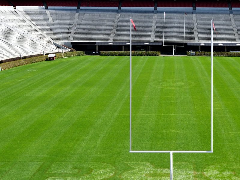 An empty football stadium field with goal posts