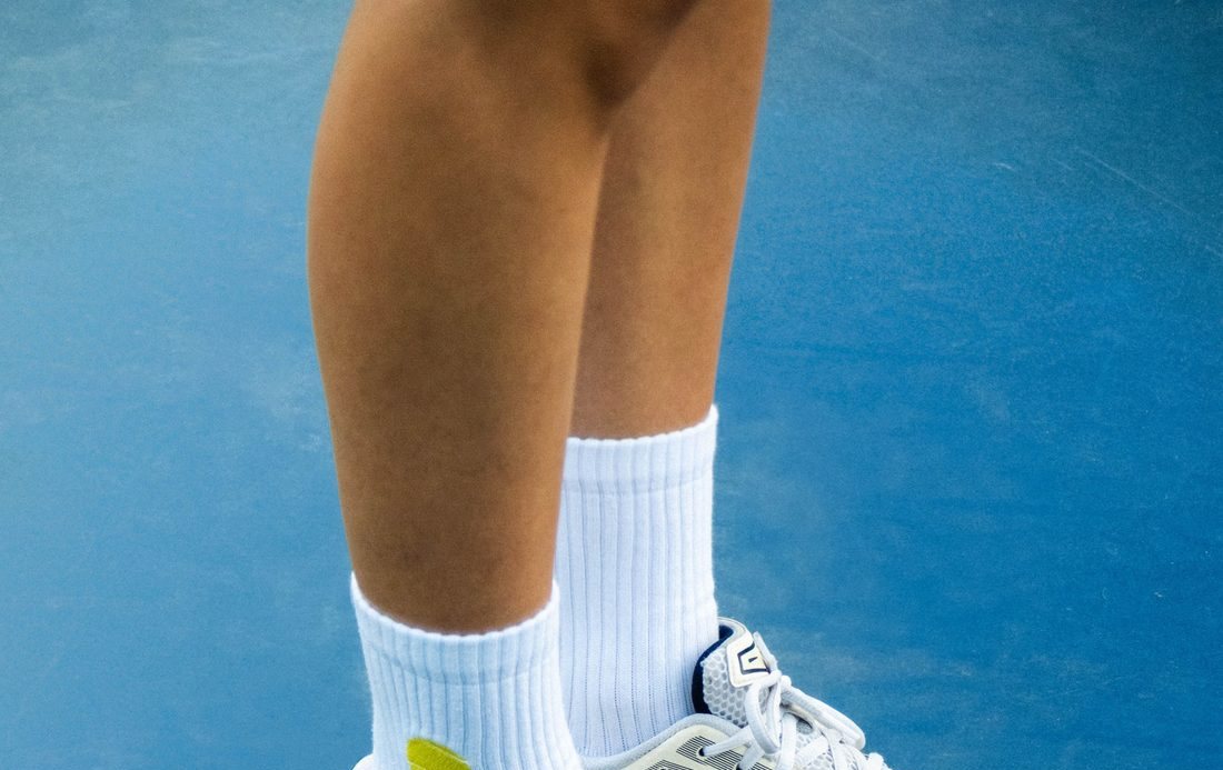 White crew socks on a blue sports court