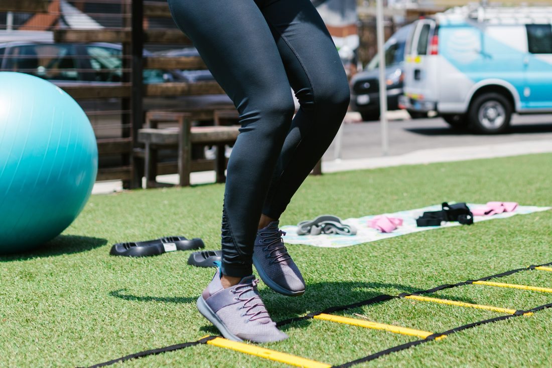 Athlete stepping through an agility ladder