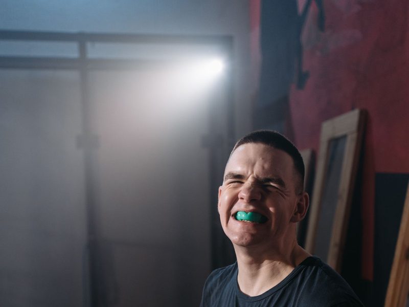 An athlete wearing a blue mouthguard